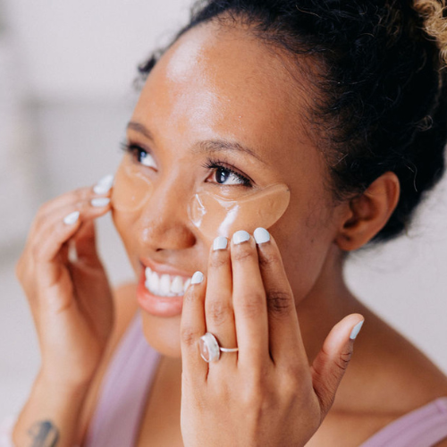 A black woman shown wearing Frownies cactus collagen under eye gels 