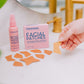 Frownies facial patches (CEM) and rose water hydrator spray shown sitting by a sink, while the facial patches are also laying on the sink counter top next to the packaging 