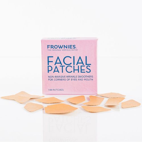 A pink box displays Frownies facial patches designed for the corners of the eyes and mouth. The patches are intended to reduce wrinkles in these areas and are neatly arranged in the box.