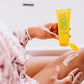 Frownies cellulite cream being squeezed out the bottle onto her thigh area, showing how the cream looks