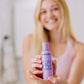 a white woman with blonde hair shown holding Frownies PH balancing face wash 