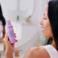 A woman with black hair pictured holding Frownies PH balancing face wash 