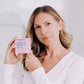 A white woman shown wearing Frownies gentle lifts while holding the gentle lifts package in her hands 