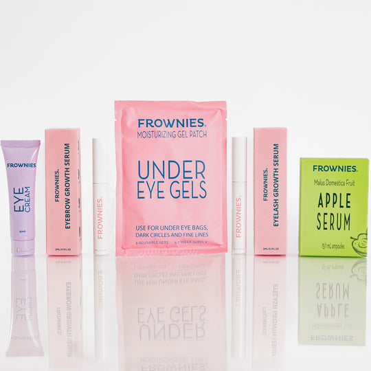 Frownies under eye gels pictured with brow and lash serum, apple serum, and eye cream, showcasing some of Frownies products.