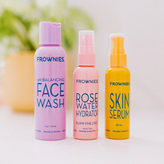 Frownies pH Balancing Face Wash, Frownies Rose Water Hydrator, and Frownies Skin Serum bottles displayed side by side.